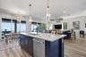 Open concept kitchen dining and living room with expansive views of Tampa Bay and Skyway Bridge