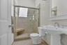 Full bathroom with baseboards, a shower stall, toilet, and tile patterned floors