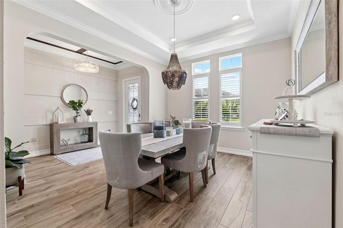The dining room is lit with natural lighting and warm bright colors.