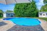 Swimming pool featuring a storage shed, a yard, and a patio