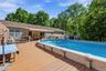 Expansive wood-finish deck surrounding an above-ground pool