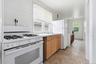 White gas range with four burners and a matching white refrigerator