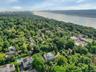 Bird's eye view of a nearby body of water and a heavily wooded area