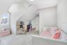 Another view of bedroom with plenty of space and cool angled ceilings.