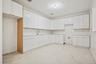 Kitchen featuring white cabinets, light countertops, and modern cabinets