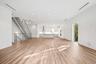 Bright, open, kitchen and living space with Miele and Samsung appliances.