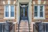 Entrance to property featuring brick siding, a gate, and french doors
