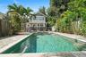 Looking back toward the home, the pool and surrounding patio showcase the property’s inviting indoor-outdoor lifestyle.