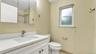 Bathroom with vanity, toilet, a shower, and tile patterned floors