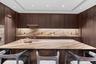 Kitchen with a sink, modern cabinets, a breakfast bar area, and dark brown cabinets