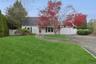 View of front of property with driveway and a garage