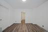Unfurnished room featuring dark wood finished floors and baseboards