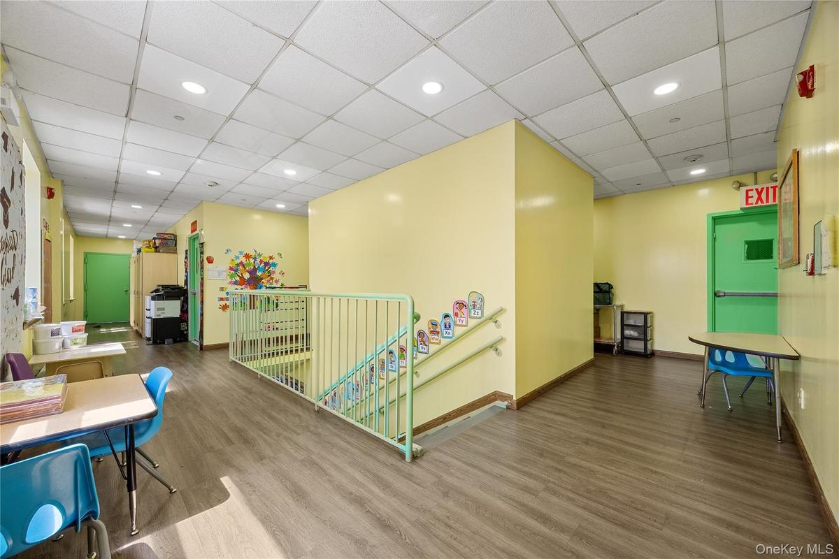Playroom featuring wood finished floors, a drop ceiling, and recessed lighting