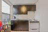 Kitchen featuring gas range gas stove, tasteful backsplash, dark countertops, and dark brown cabinetry