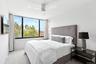 Carpeted bedroom featuring baseboards, a ceiling fan, and visible vents