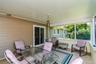 Screened porch featuring a sliding glass door, overhead lighting fixture, and exterior siding