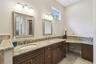 Owner's bathroom with double sinks, vanity area and granite countertops.