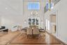 Dining room with recessed lighting, light wood-type flooring, a chandelier, and a high ceiling