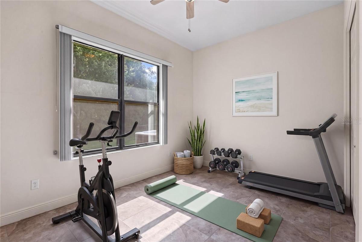 The fourth bedroom enjoys peaceful conservation views and exceptional backyard privacy. - virtually staged
