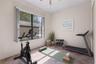 The fourth bedroom enjoys peaceful conservation views and exceptional backyard privacy. - virtually staged
