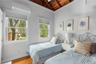 Bedroom featuring wooden ceiling, a wall mounted air conditioner, wood finished floors, and lofted ceiling