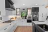 featuring custom cabinetry, quartz countertops, and ample storage