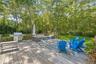 Wooden deck featuring an outdoor hangout area, a lawn, and area for grilling
