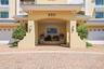 Private secured building entrance with elegant coastal architecture.