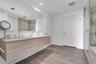 Primary bath with dual vanities, soaking tub, and walk-in shower