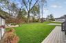 Inviting flat backyard with a patio perfect for summer evenings and weekend relaxation.