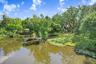 Drone view of spring fed lake, floating dock and backyard.