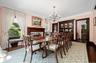 Formal and fabulous with wood burning fireplace, original built-in breakfront and glassware closet, oversized windows, wood floors, moldings and swing