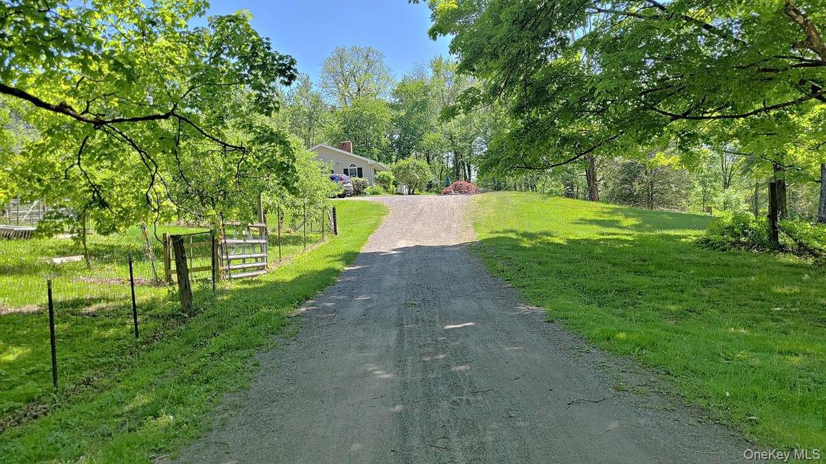 Gravel driveway ascending to the property