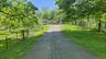 Gravel driveway ascending to the property