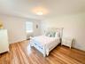 Bedroom with radiator, crown molding, and light hardwood / wood-style flooring