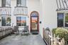 Arched brick entry with a glass-paneled door