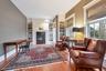 Living room with built in shelves and hardwood / wood-style flooring