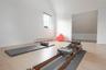 Workout room with lofted ceiling and a baseboard heating unit