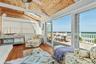 Sunroom featuring wood-finish flooring and a natural wood plank ceiling with exposed beams