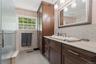 Bathroom with wood-finish cabinetry and a light countertop