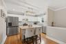Kitchen featuring white cabinetry, stainless steel appliances, a wood-finish island, and recessed lighting