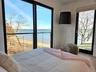 Bedroom with a water view and wood finished floors