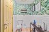 Bathroom with a paneled ceiling, wallpapered walls, a wainscoted wall, tile walls, and tile patterned floors