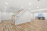 Big basement with 4 oversized egress windows wood floor look luxury vinyl