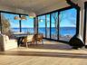 Sunroom featuring a wood stove and a water view