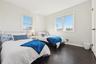 Bedroom with dark hardwood / wood-style flooring