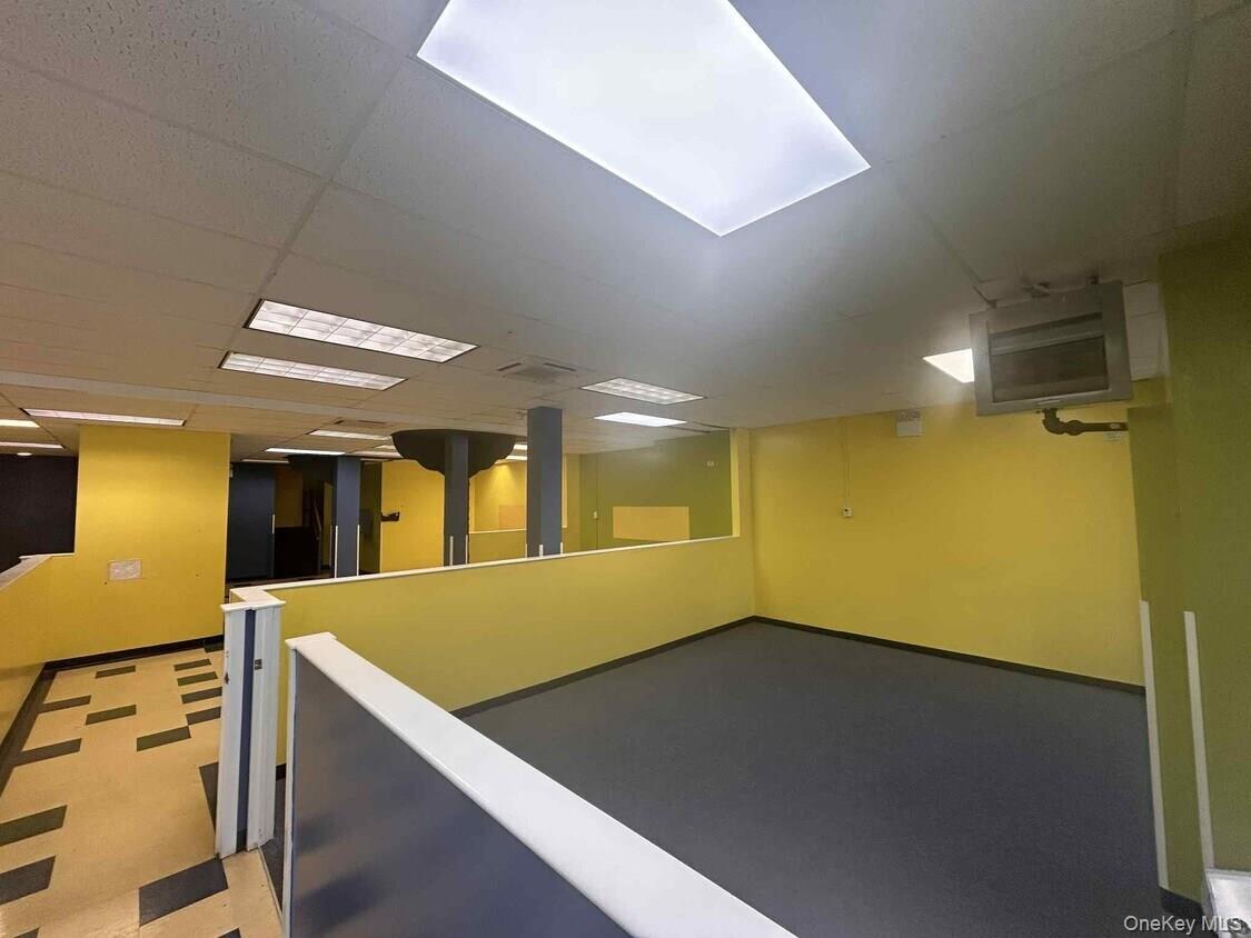 Below grade area with a paneled ceiling and a heating unit