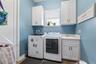 The laundry room is spacious and offers storage closets as well.