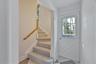 Entrance foyer featuring plenty of natural light, stairway, and light floors