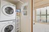 Washroom with stacked washing machine and dryer